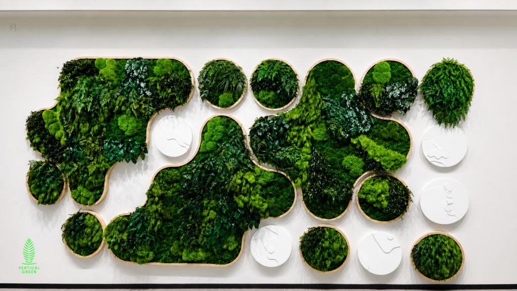 Preserved moss and foliage feature wall at MSD Pharma Singapore featuring custom organic-shaped HygroPreserved green panels in a modern minimalist office interior.