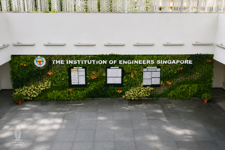 Large living green wall installation displaying The Institution of Engineers Singapore signage in a bright open atrium with contemporary architectural finishes.